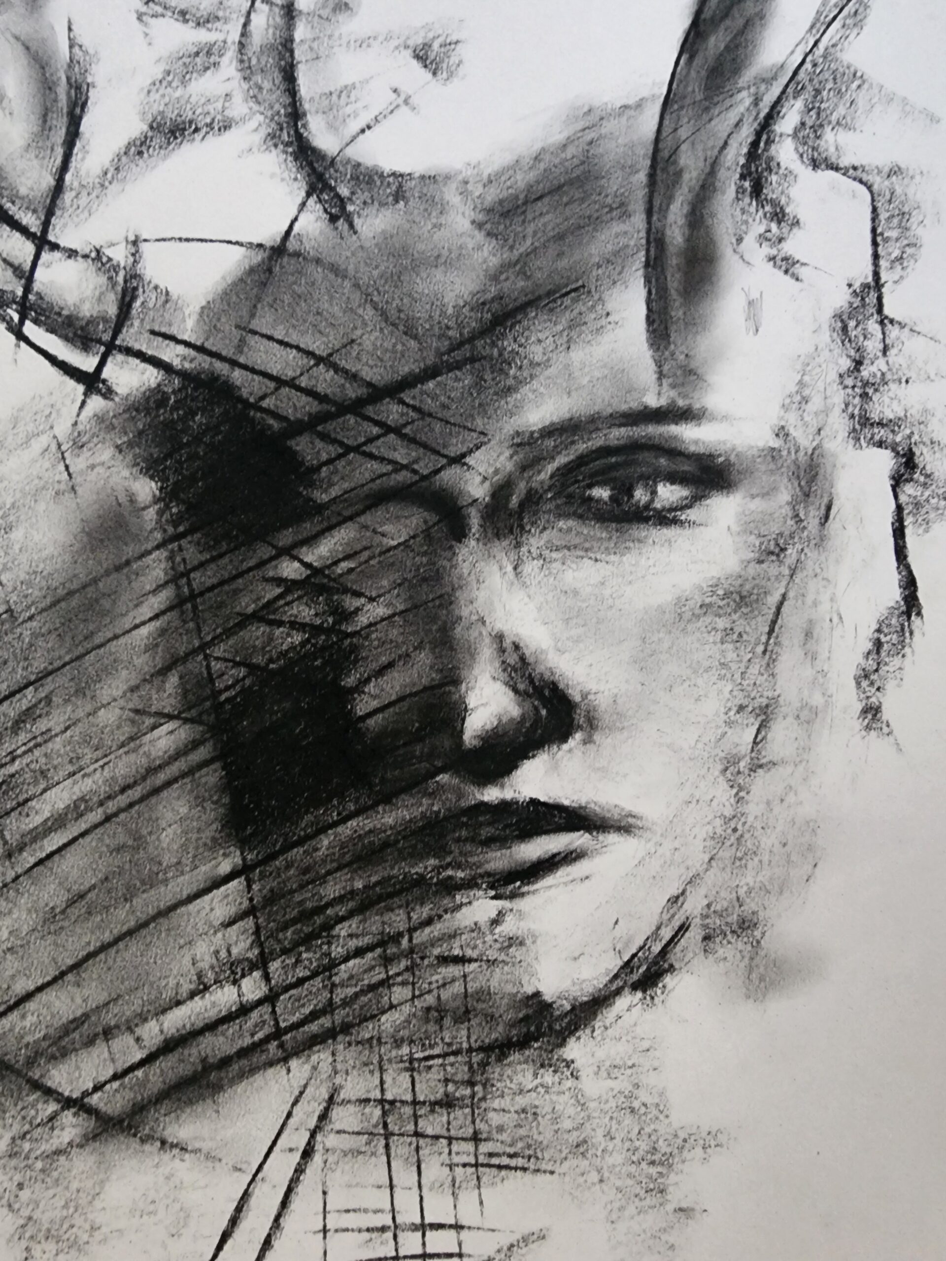charcoal sketch of a human face distorted by shadows